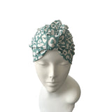 Turban with a leopard print pattern on a mannequin head against a white background