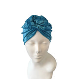 Blue headscarf on a mannequin head against a white background