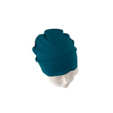 Teal beanie on a mannequin head against a white background