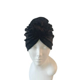 Black headscarf on a mannequin head against a white background