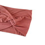 Pink headband with a knot on a white background