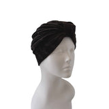 Black velvet turban on a mannequin head against a white background