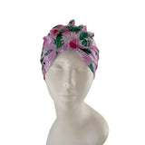 Pink headband with tropical leaf pattern on a mannequin head against a white background
