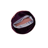 Brown makeup compact with a white lining on a white background