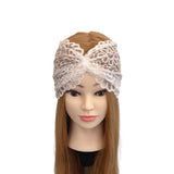 White lace headband on a mannequin head with brown hair against a white background