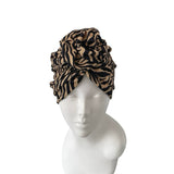 Leopard print headscarf on a mannequin head against a white background