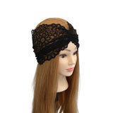 Black lace headband on a mannequin head with long brown hair against a white background