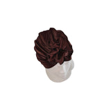 Brown headscarf on a mannequin head against a white background