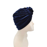 Navy blue turban on a mannequin head against a white background
