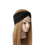 A black fabric twisted headband displayed on a mannequin head with long light brown hair, set against a plain white background.