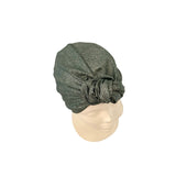 Green textured headscarf on a mannequin head against a white background