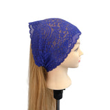 Blue lace headscarf on a mannequin head against a white background