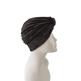 Black headscarf on a mannequin head against a white background