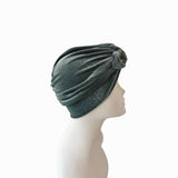 Green headscarf on a mannequin head against a white background