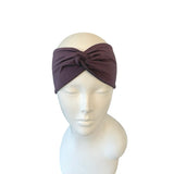 Brown headband on a mannequin head against a white background