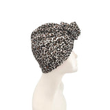 Leopard print headscarf on a mannequin head against a white background