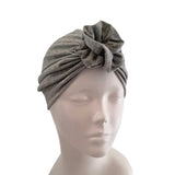 Gray turban on a mannequin head against a white background