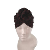 Brown velvet turban on a mannequin head against a white background