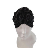Black headband with floral design on a mannequin head against a white background