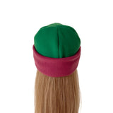 A green and magenta fleece elf hat with a blonde mannequin wig, shown from the back on a white background.