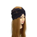 Black lace headband on a mannequin head with long brown hair against a white background