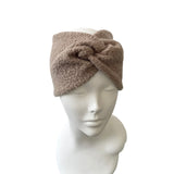 Brown headband on a mannequin head against a white background
