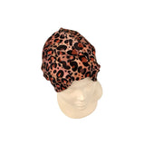 Leopard print headscarf on a mannequin head against a white background