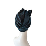 Dark blue textured headscarf on a mannequin head against a white background