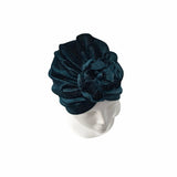 Dark blue knit headband on a mannequin head against a white background
