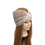 White lace headband on a mannequin head with long brown hair against a white background