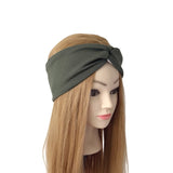 An olive green twisted fabric headband displayed on a mannequin head with long light brown hair, set against a plain white background.