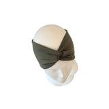 Green headband on a mannequin head against a white background