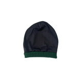 Black beanie with green rim on a white background