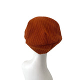 Brown knit beanie on a mannequin head against a white background