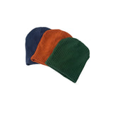 Three knit beanie hats in blue, orange, and green on a white background