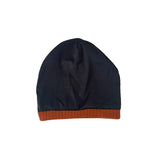 Black beanie with brown rim on a white background