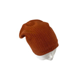 Brown knit beanie on a white mannequin head against a white background