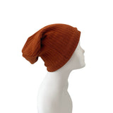 Brown knit beanie on a mannequin head against a white background