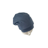 Blue knit beanie on a mannequin head against a white background