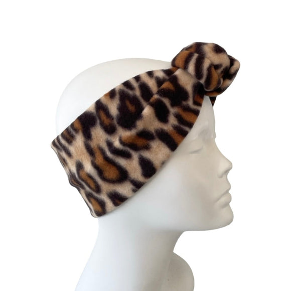 Leopard print headband on a mannequin head against a white background