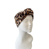 Leopard print headband on a mannequin head against a white background
