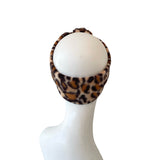 Leopard print headband on a mannequin head against a white background