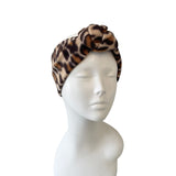Leopard print headband on a mannequin head against a white background