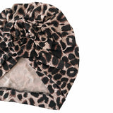 Leopard print headscarf with a textured fabric on a white background