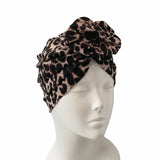 Leopard print headband on a mannequin head against a white background