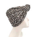 Leopard print headscarf on a mannequin head against a white background
