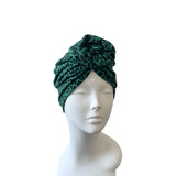 Green leopard print headscarf on a mannequin head against a white background