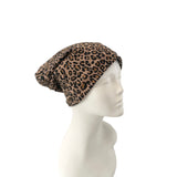 Leopard print headscarf on a mannequin head against a white background