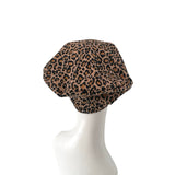 Leopard print headscarf on a mannequin head against a white background