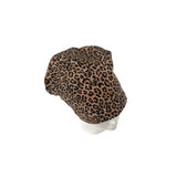 Leopard print headscarf on a mannequin head against a white background